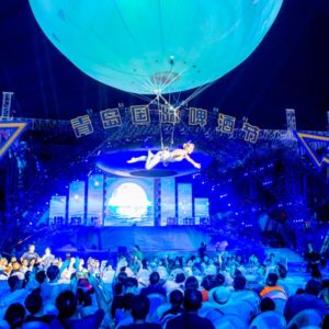 giant aerial balloon, aerial sphere, aerial show, white giant balloon in the air, trapeze show under a bubble, aerial bubble