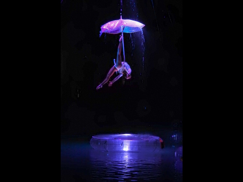aerial performers, water structures, aquatic events, floating platforms, aerialists, water spectacle, aerial dance, umbrella performance, floating stage, water artistry