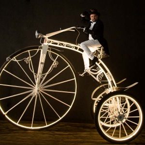 luminous cycling, illuminated bicycle show, giant bicycle performer, roaming entertainment, LED roaming act, interactive event entertainment, light performance, corporate event entertainment, festival entertainment, luxury event entertainment